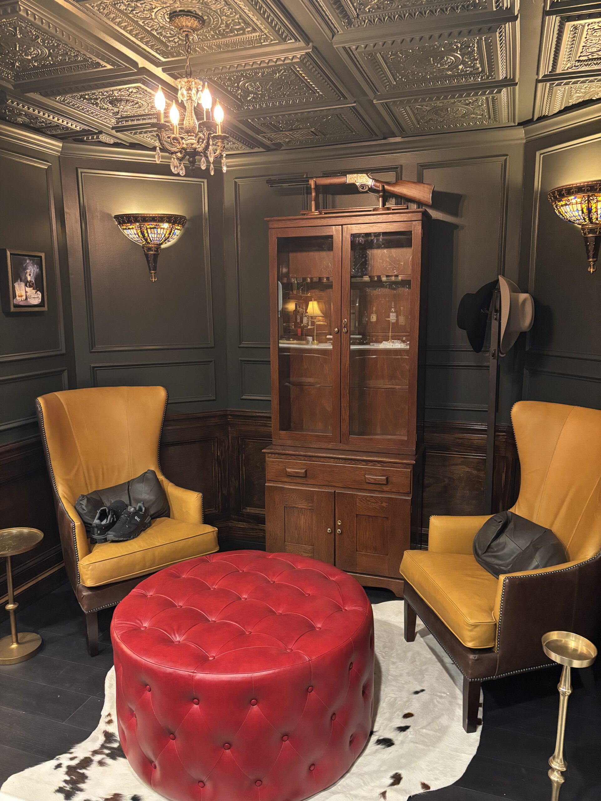 Basement lounge with red ottoman and yellow armchairs