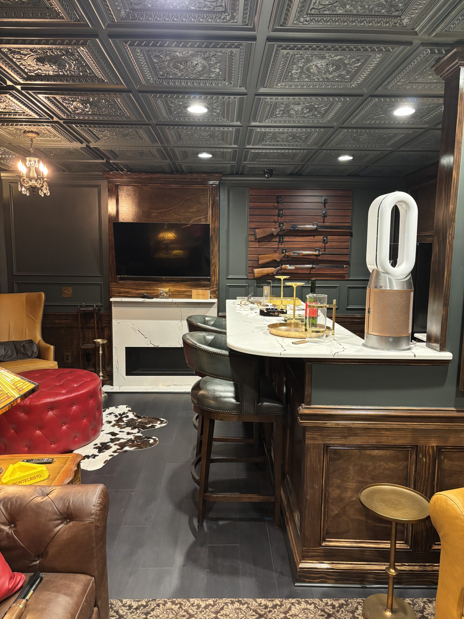 Finished basement with bar, seating area and tin ceiling