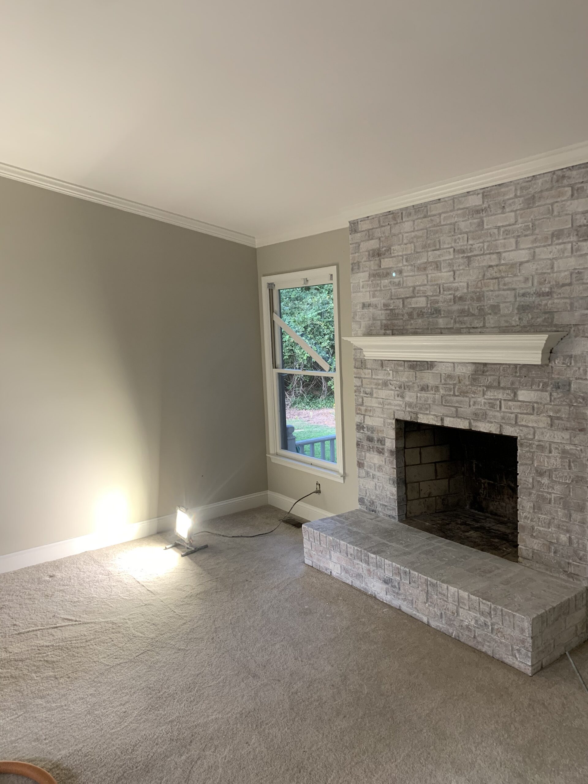 Living room with stone fireplace and carpet