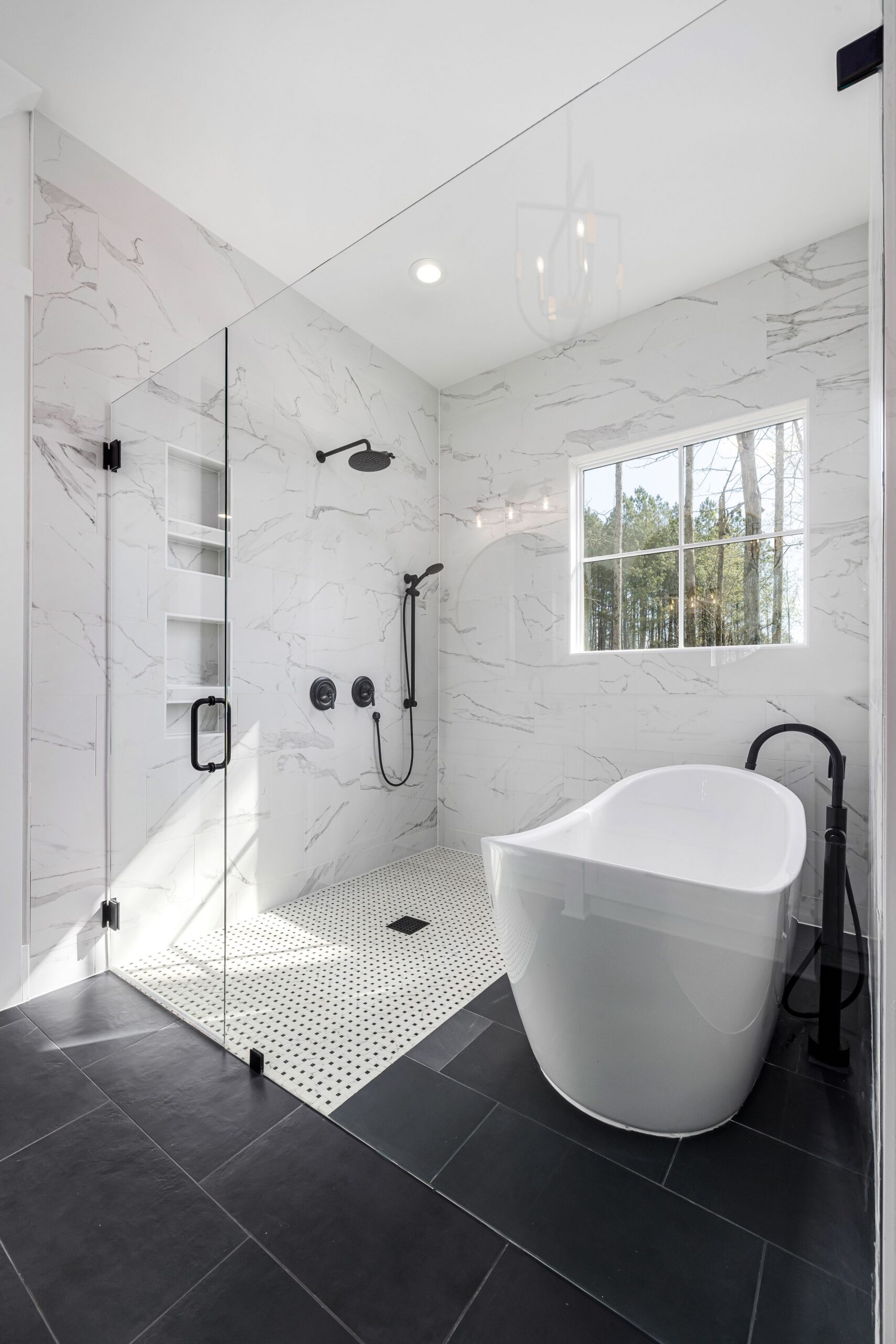 Remodeled bathroom with freestanding tub and glass shower
