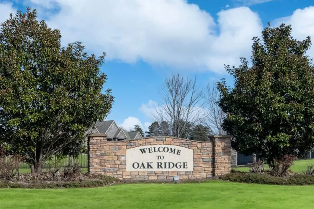 Welcome to Oak Ridge sign framed by trees in Oak Ridge, NC