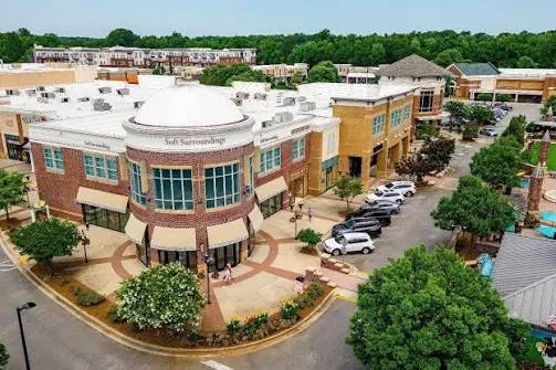 Aerial view of a shopping center and tree-lined streets in Summerfield, NC